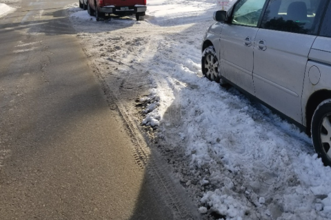 cars parked on side of snowy road