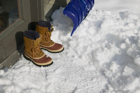 boots and shovel in snow